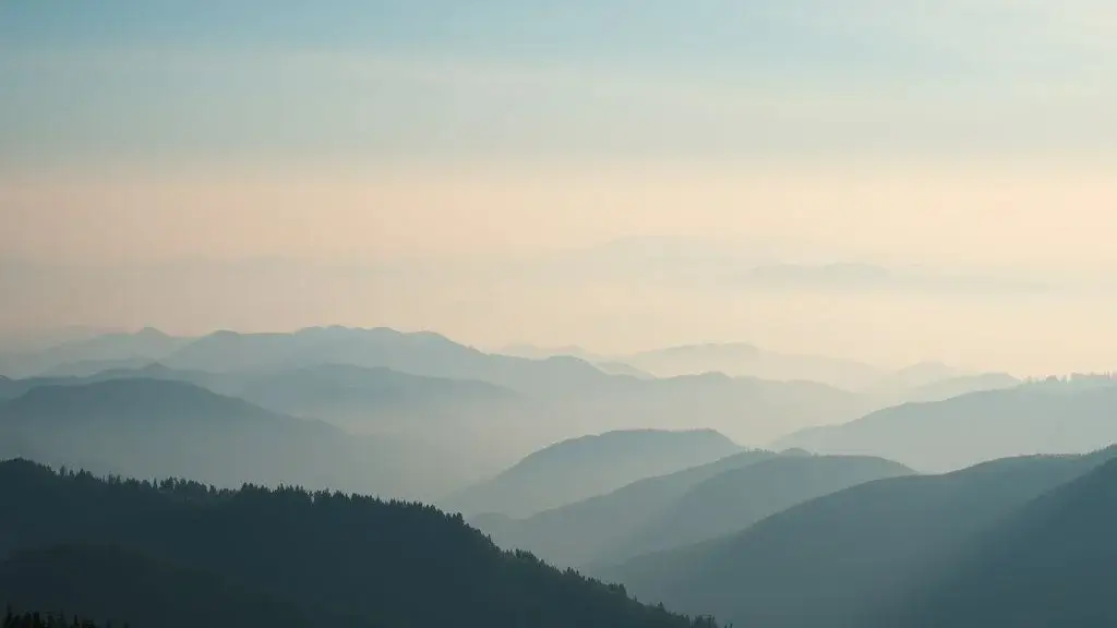 Photorealistic Midjourney result: An ethereal and tranquil landscape of misty mountains with fading peaks in the distance.